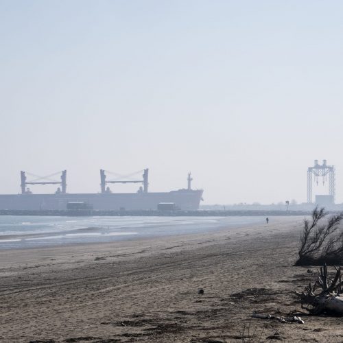 Large cargo ship sails through the entrance channel into the lagoon in front of Punta Sabbioni